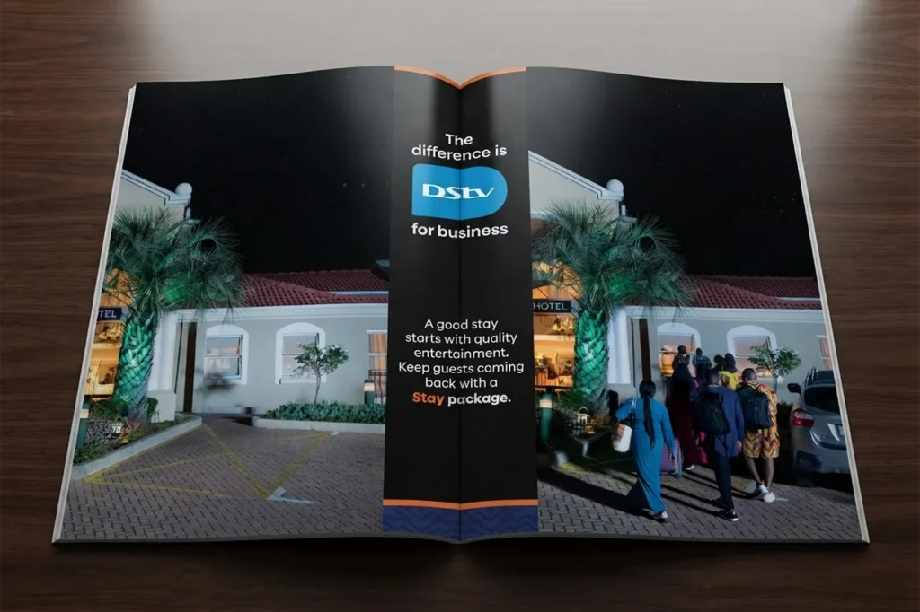Open magazine showing DStv Business hotel stay package advert