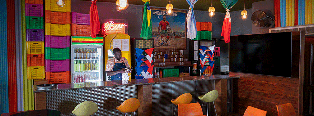 Colourful bar interior with bartender and patterned décor