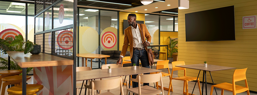 Man in café-style office seating area