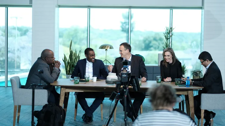 Panel discussion filmed at a modern office table