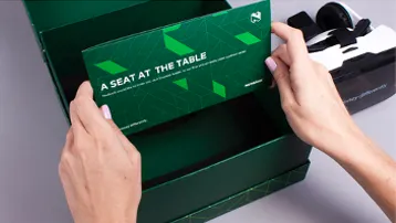 Hands unboxing green A Seat at the Table box